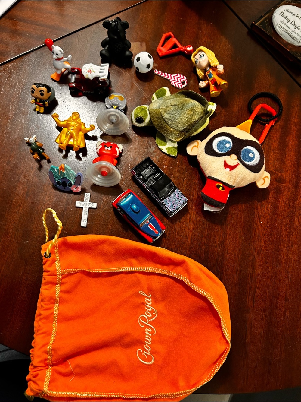Orange Drawstring Pouch with different collectibles. Found in storage unit
